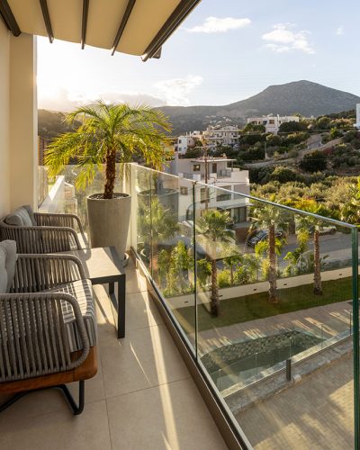 Hotel terrace with plants and glass fence